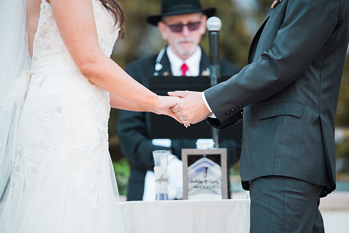 holding hands at wedding ceremony