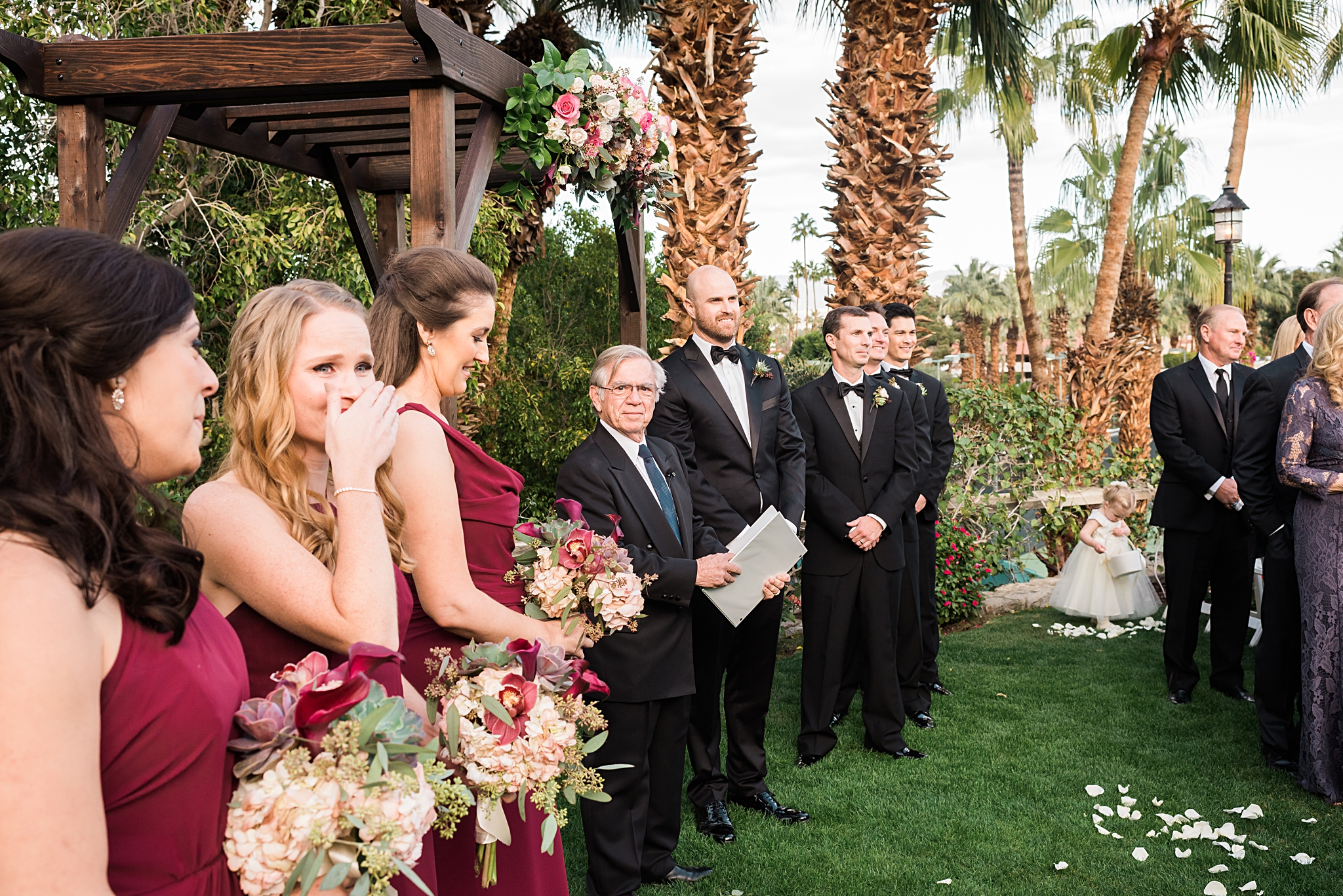 emotional bridesmaids watching bride come down the aisle