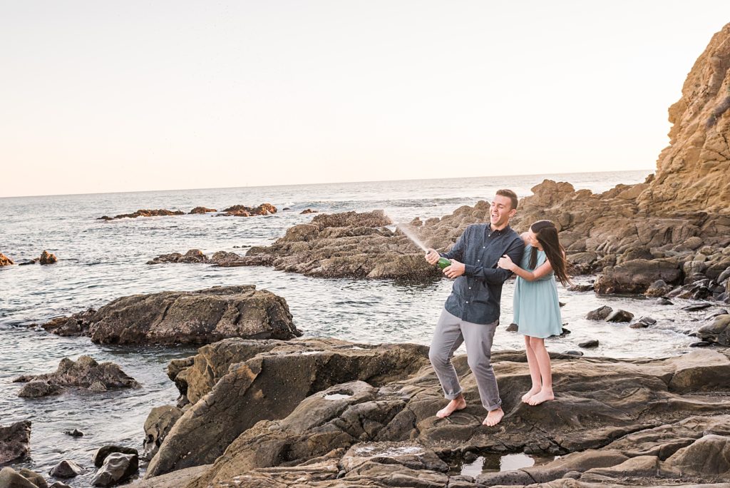 couple spraying with champagne