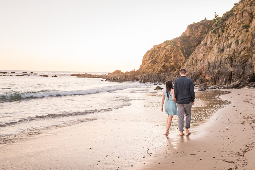 couple walking hand in hand on the beach