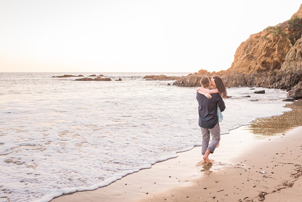 couple kissing in the surf