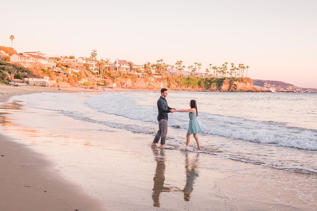 engaged couple in the surf