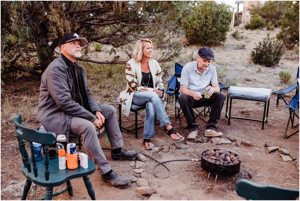 wedding guests around campfire