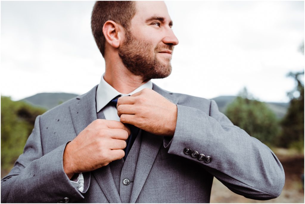groom adjusting tie