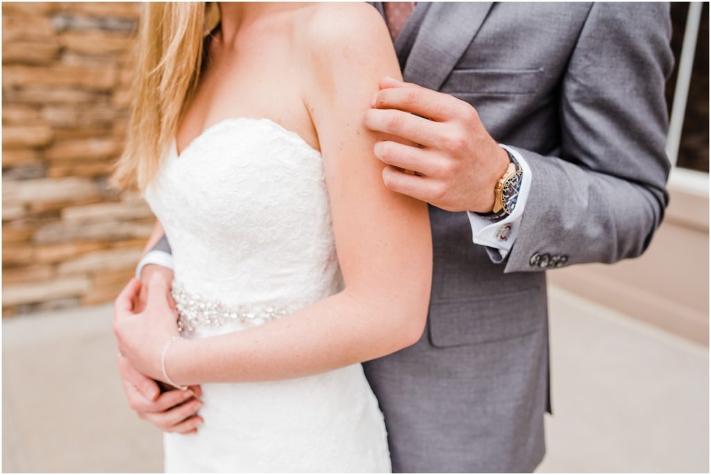 groom gently rubbing brides arm