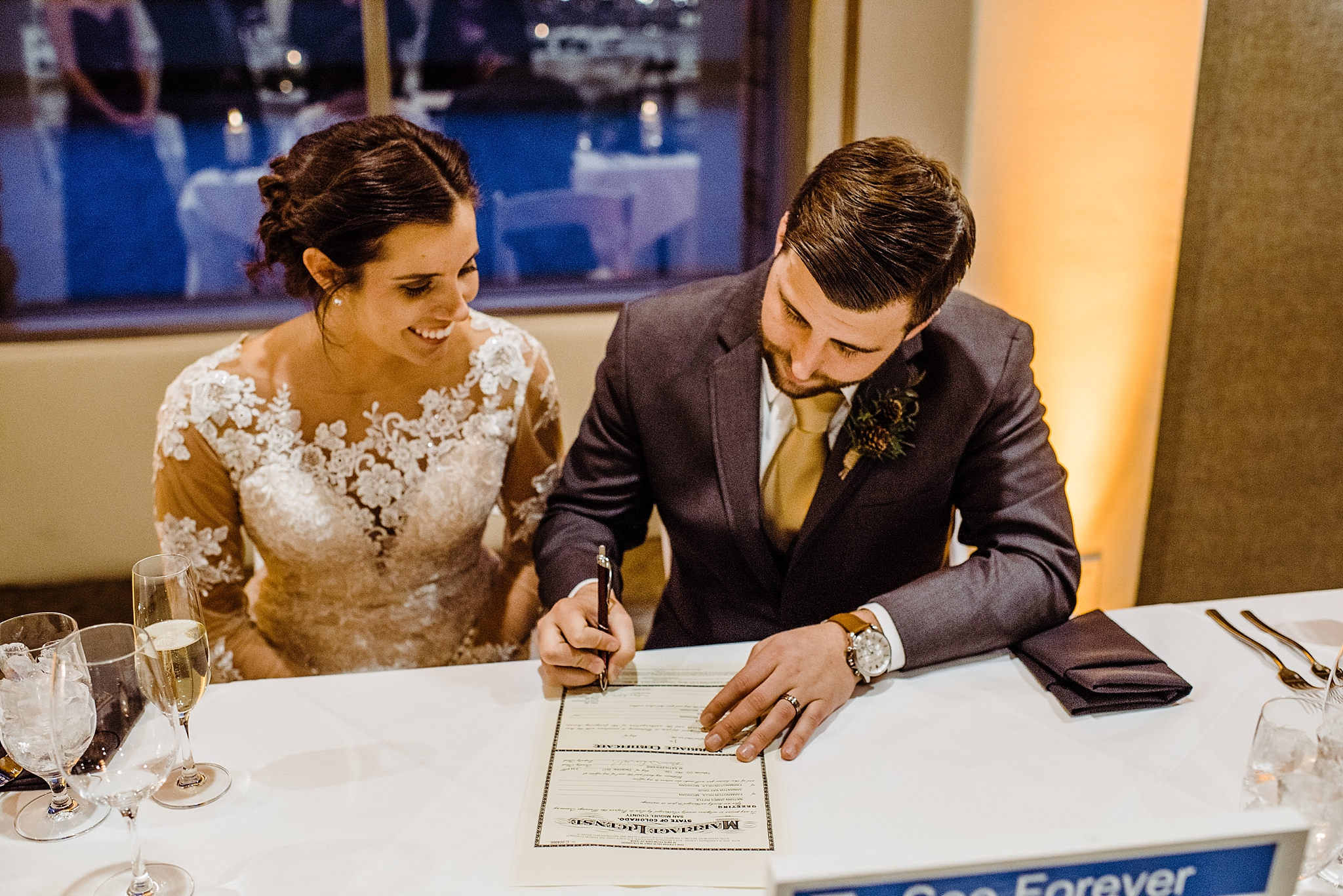 bride and groom signing their marriage certificate