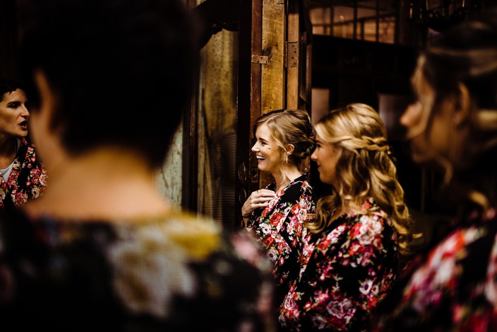 bridesmaids watching bride getting ready