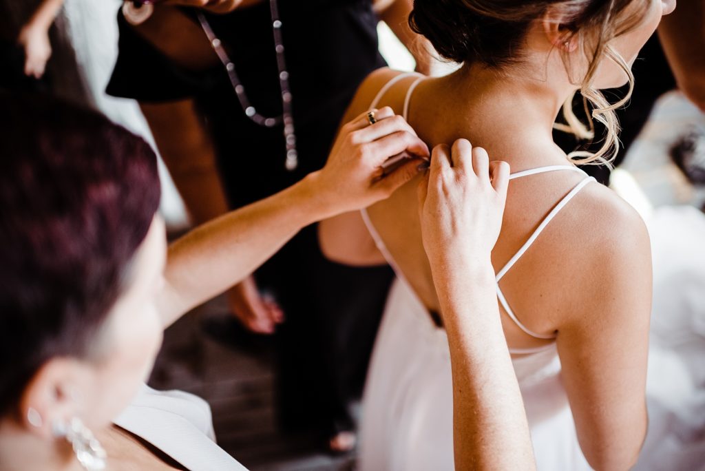 bride getting dressed at the metropolitan building in queens