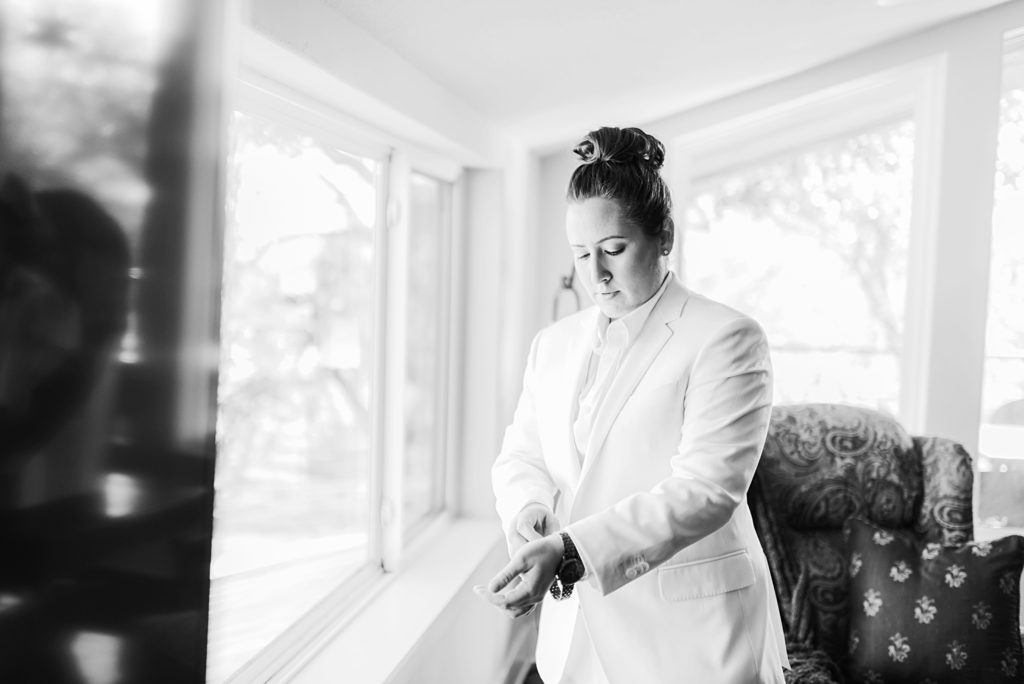 bride getting ready with suit on