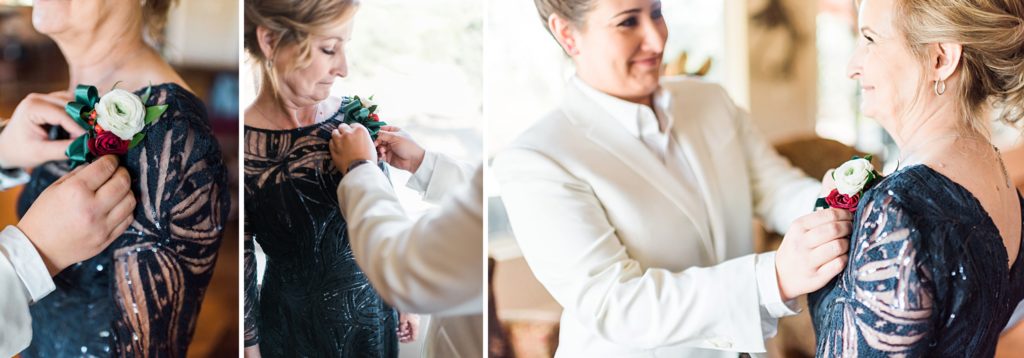 bride pinning on mother's boutonniere 
