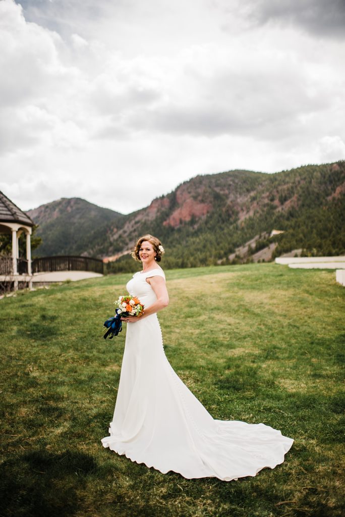 bridal portrait with green mountains behind her