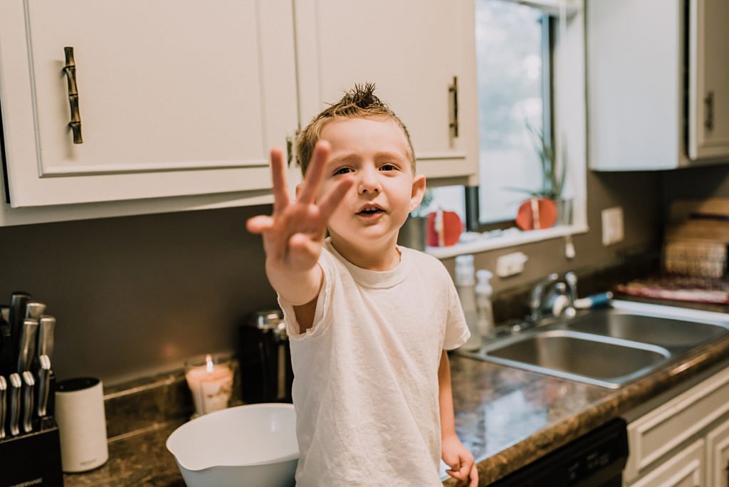 little boy showing how old he is