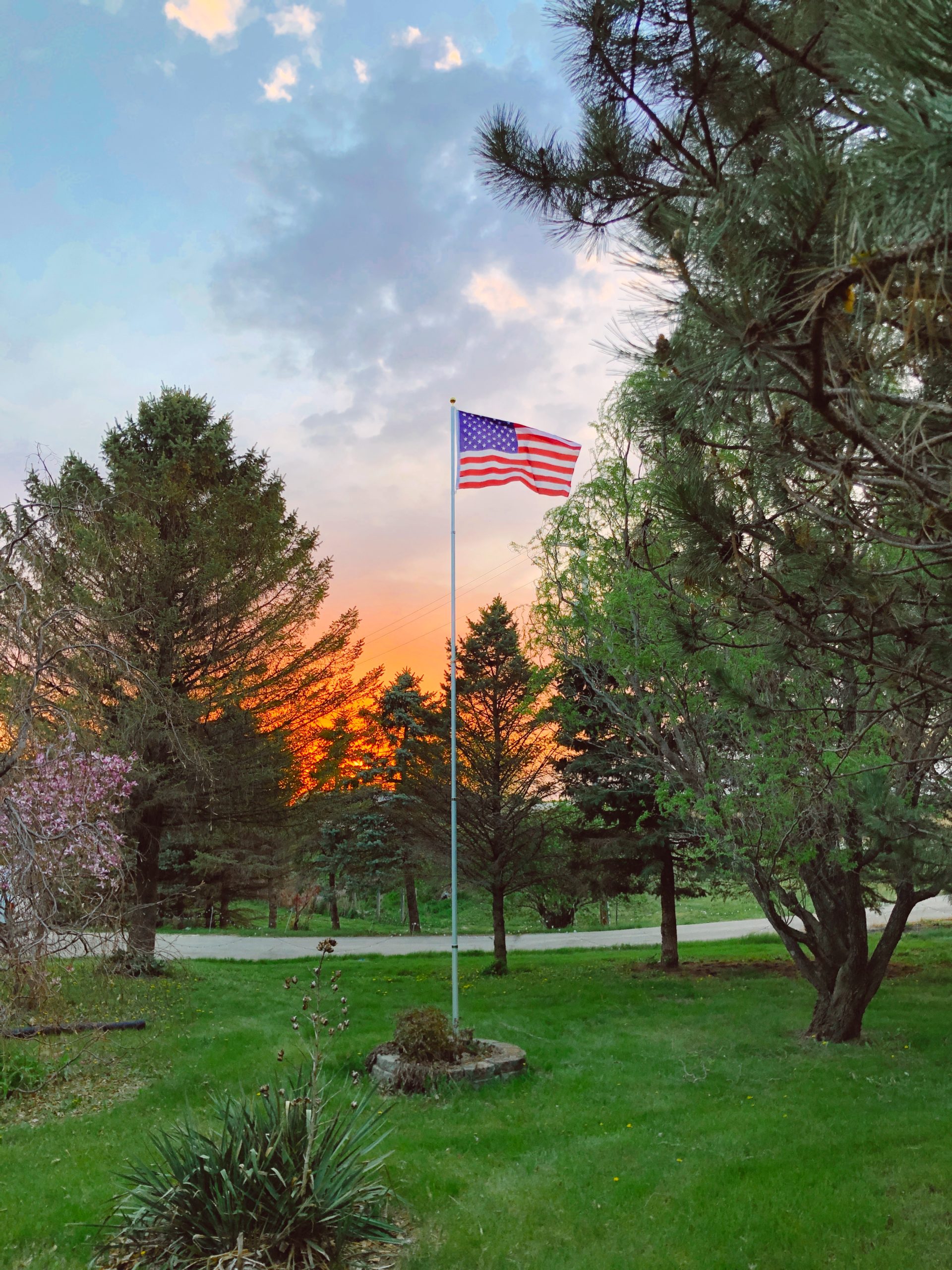 american flag waving in the sunset