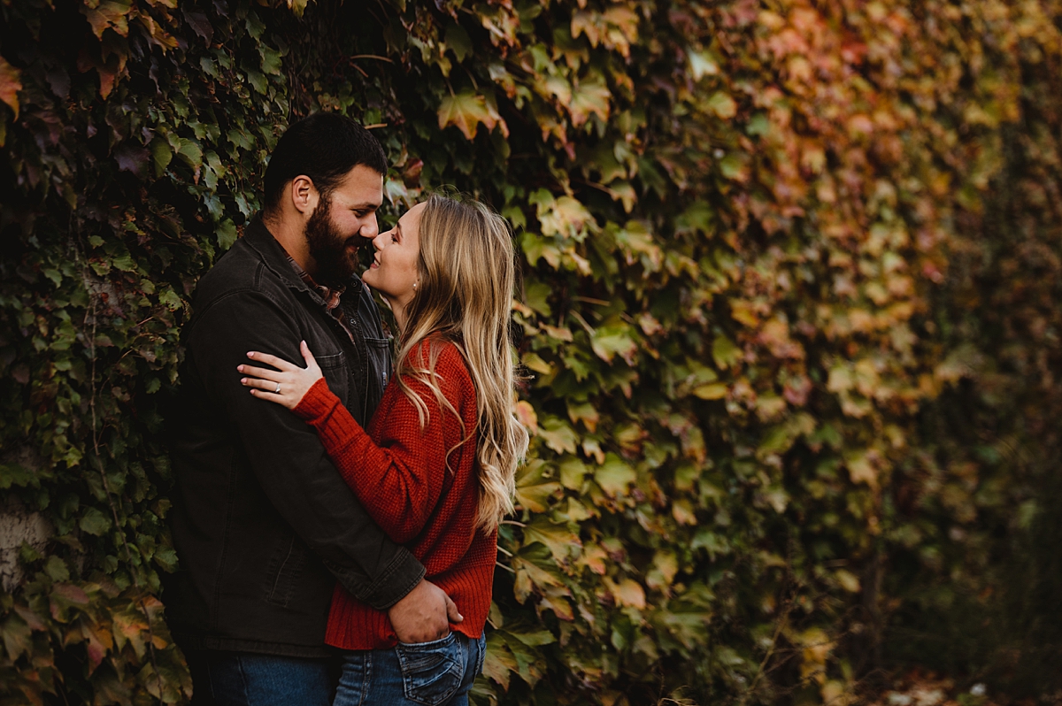 engagement photos in front of ivy covered wall in lake geneva