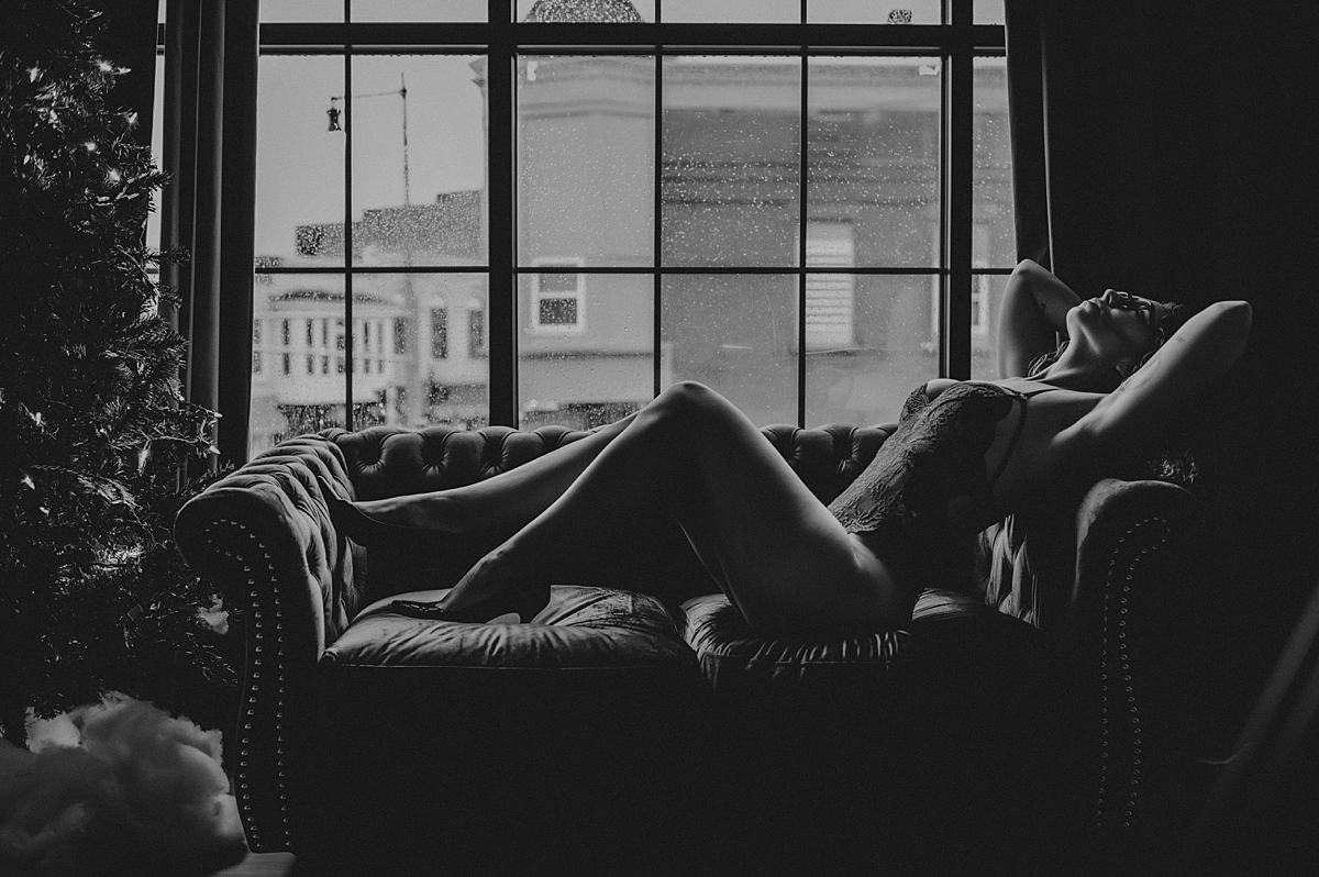 boudoir pose in front of window
