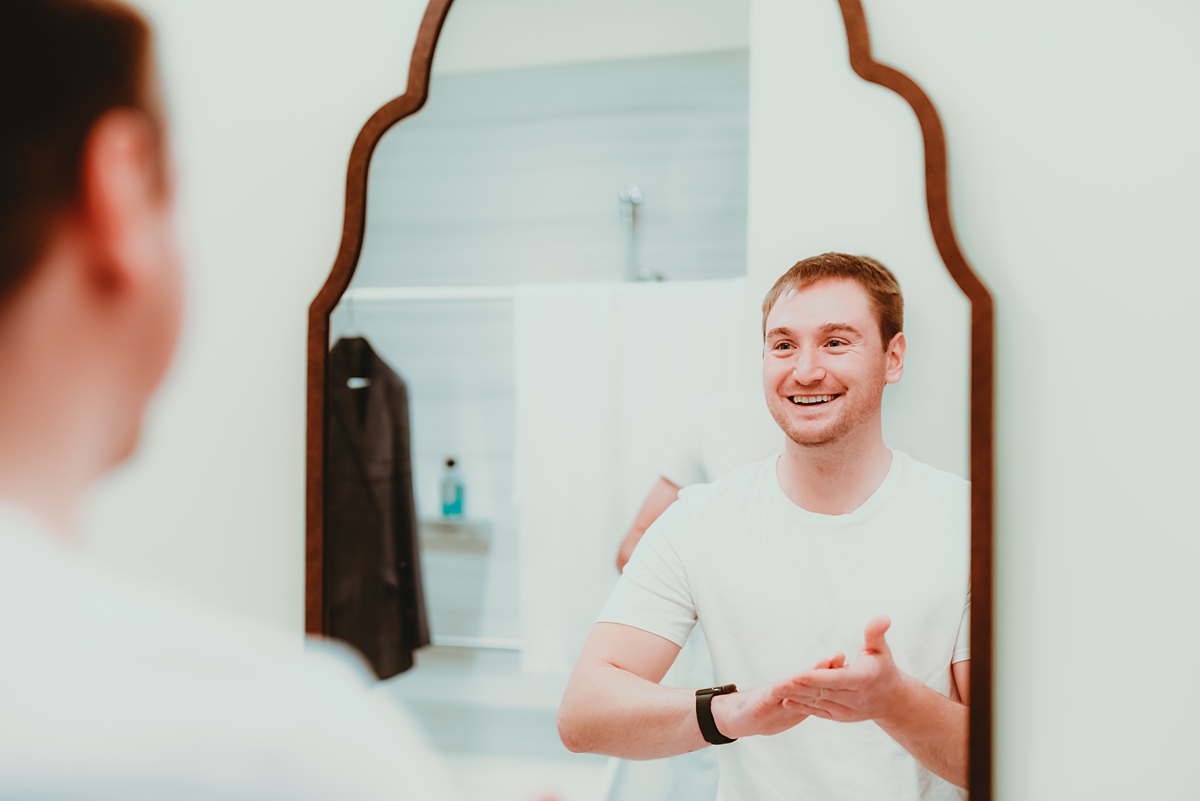 groom getting dressed for stella hotel wedding
