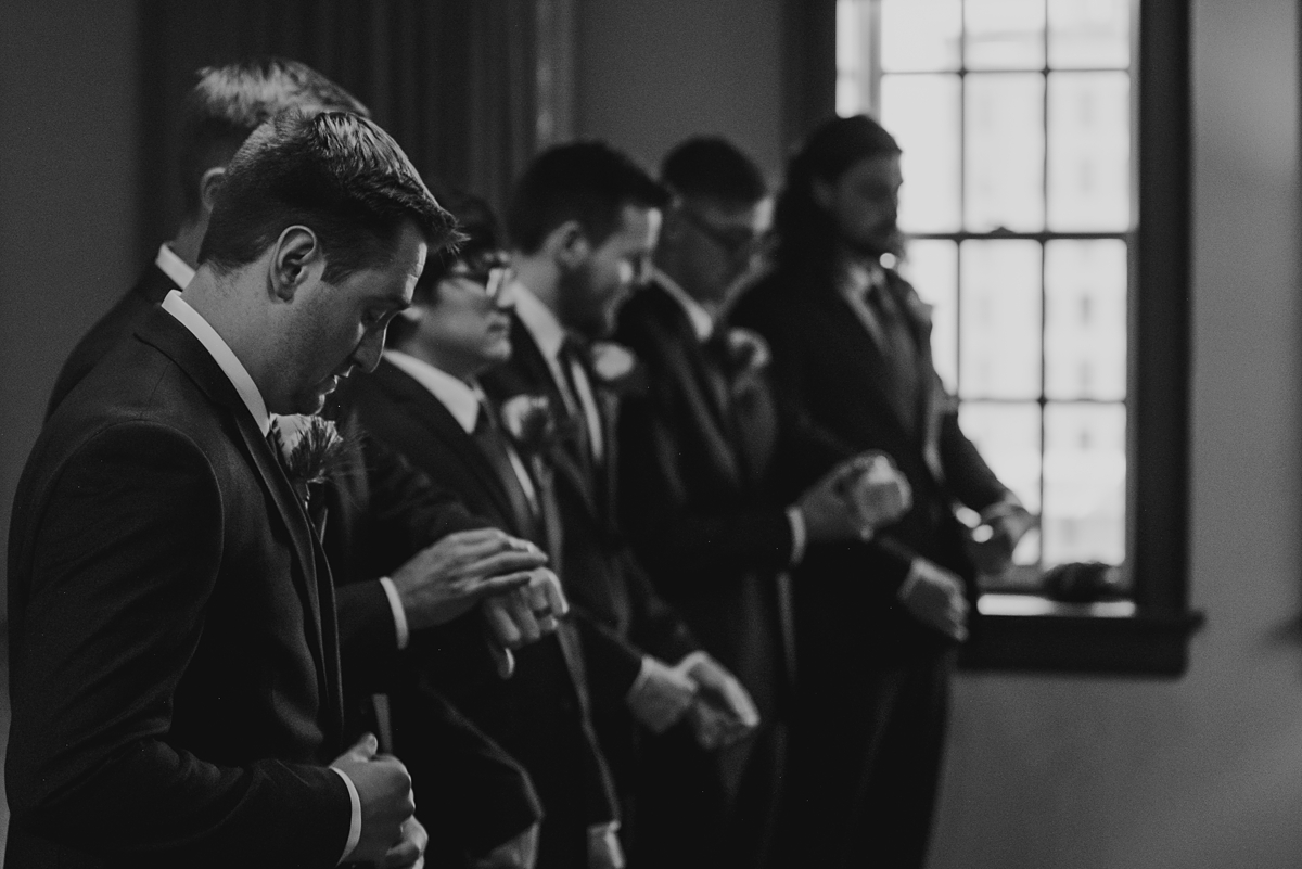 groomsmen helping groom get ready for kenosha wedding