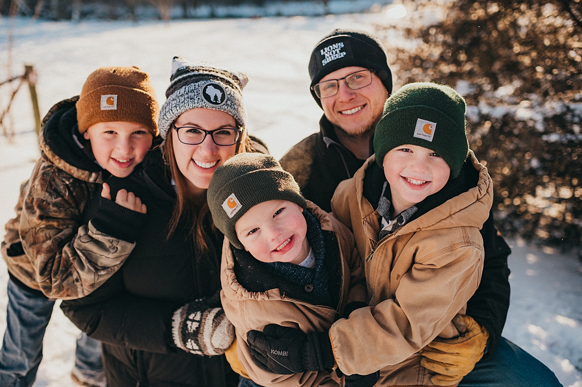 staying warm during snowy wintery family photo in Lake Geneva