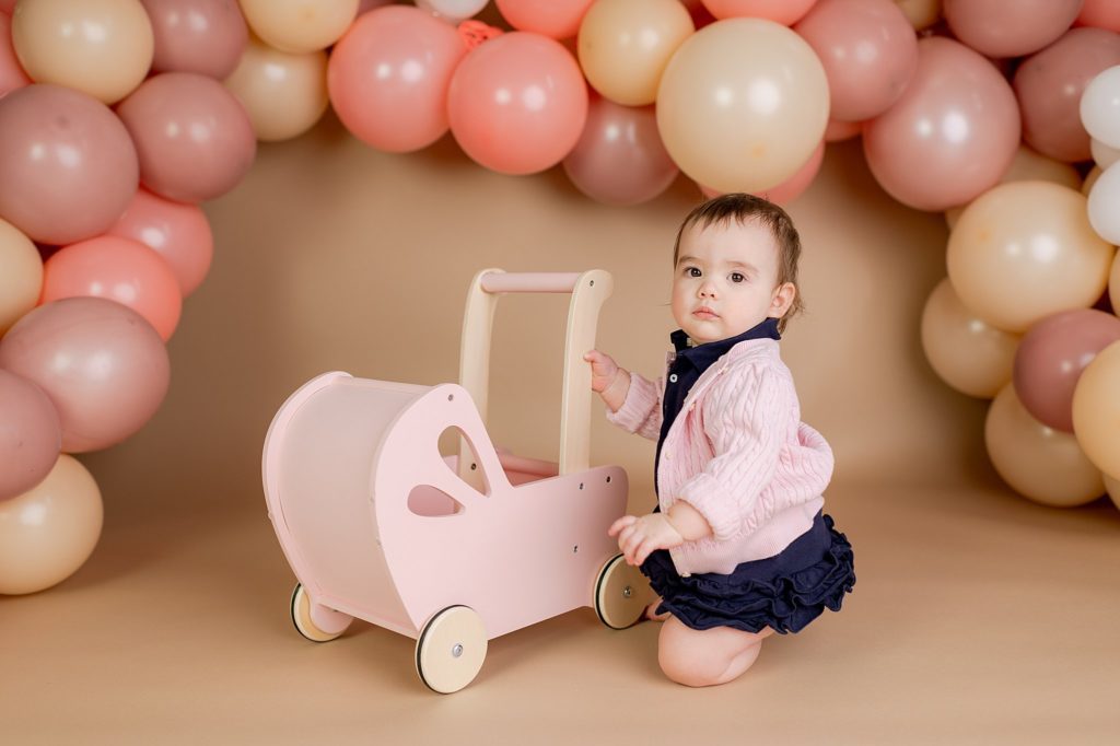 one year old photo session with baby carriage