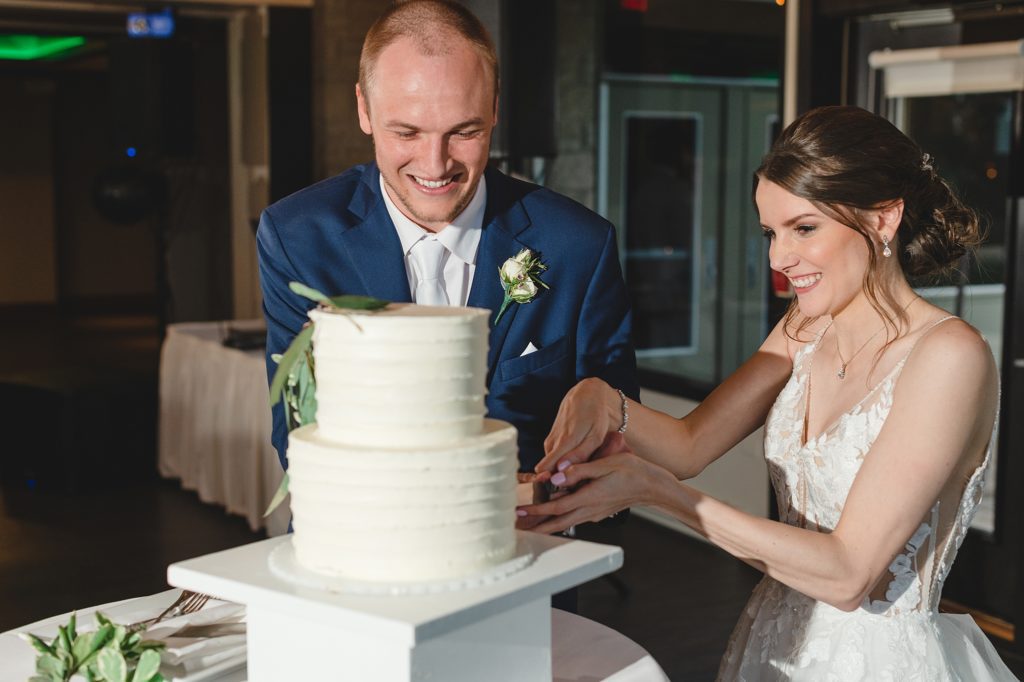 wedding couple cutting wedding cake after grand march