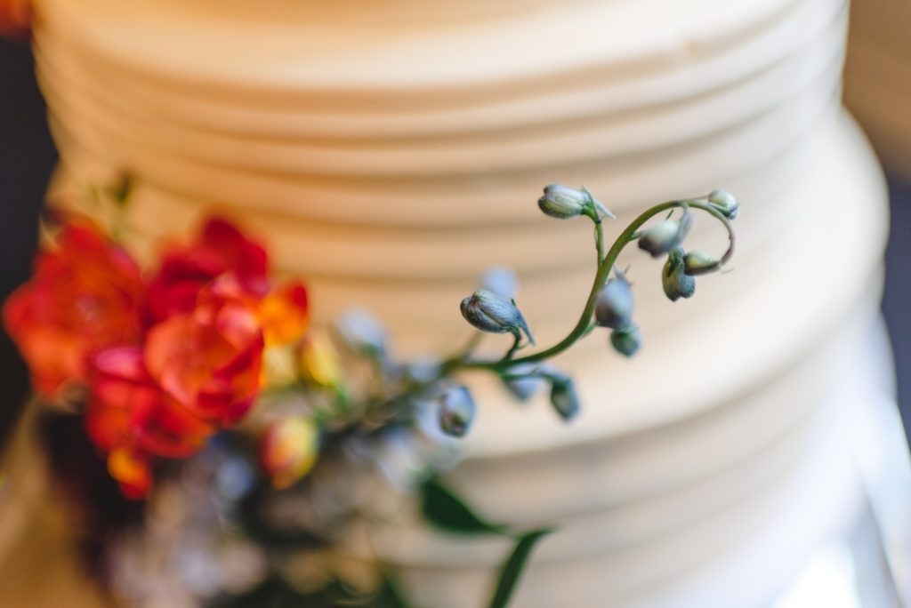 simple white wedding cake with waves and cakes