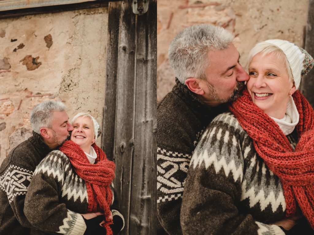 husband kissing wife on the cheek during family session