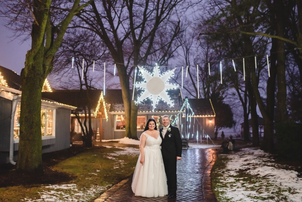 winter wedding photos at night with christmas lights and decor