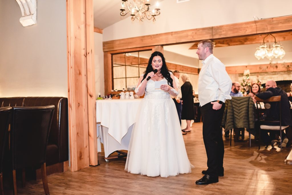 bride and groom giving toast at indoor wedding reception