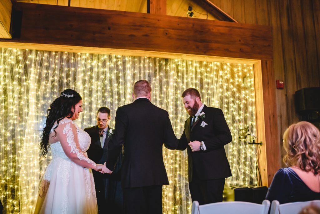 best man handing over rings at wedding ceremony
