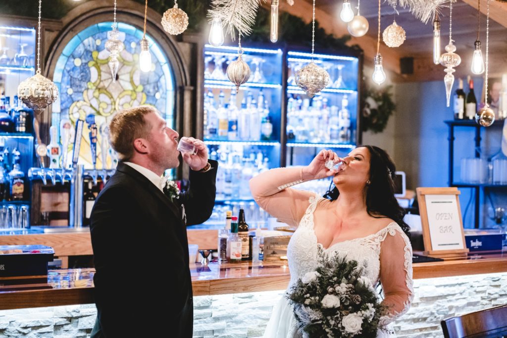 wedding couple taking shots after ceremony