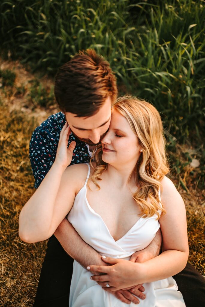 couple snuggled together for engagement photos