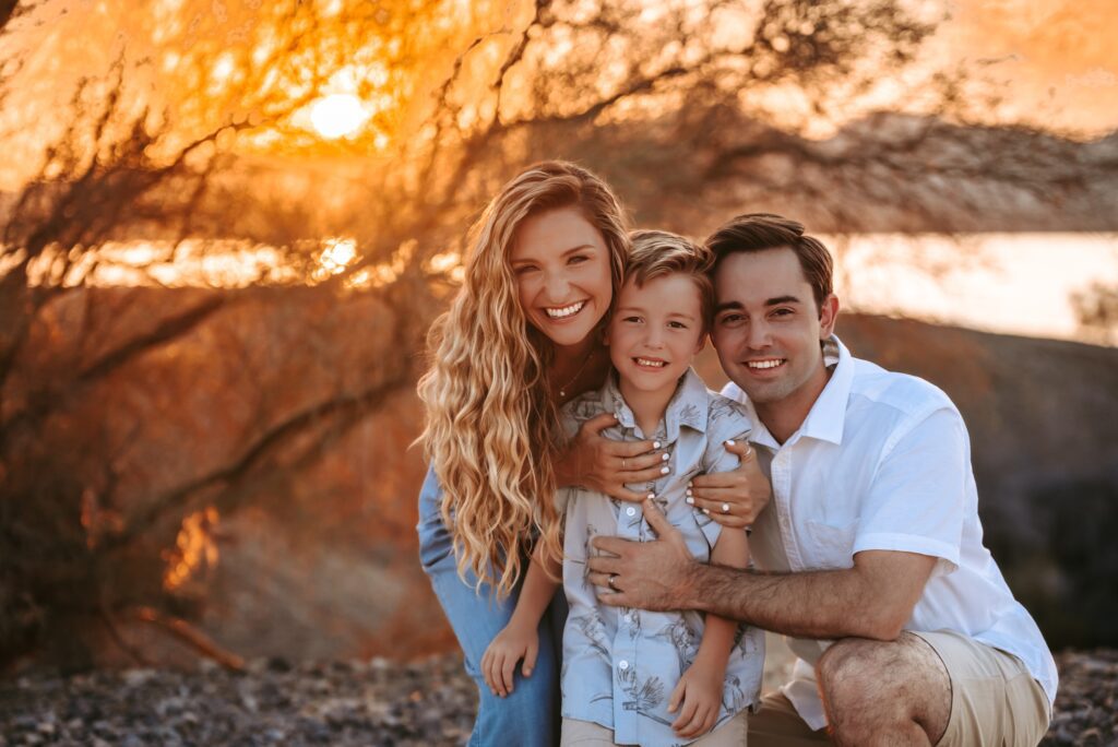 parents with little boy with beautiful sunset