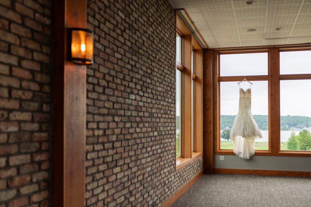 wedding dress hung up in window
