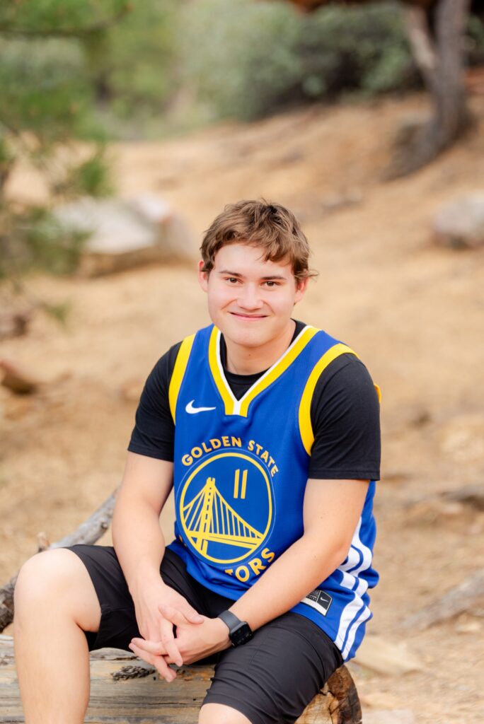 senior boy wearing warriors basketball jersey