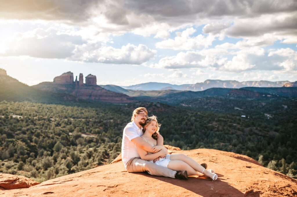 couple sitting on sedona red rocks