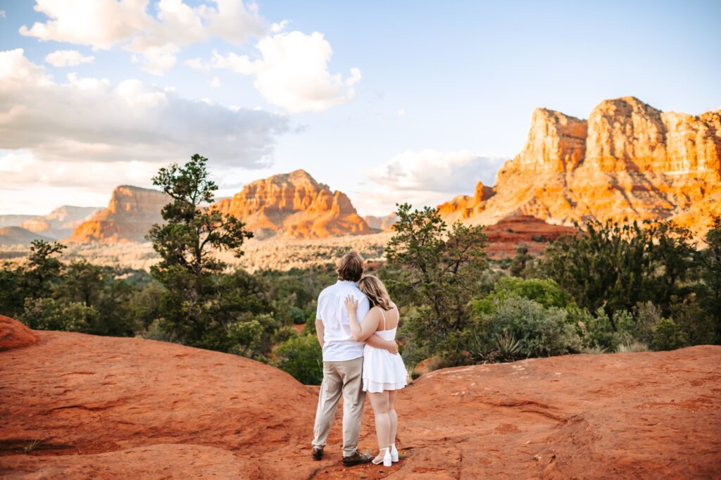 couple leaning on each other looking at the arizona mountains