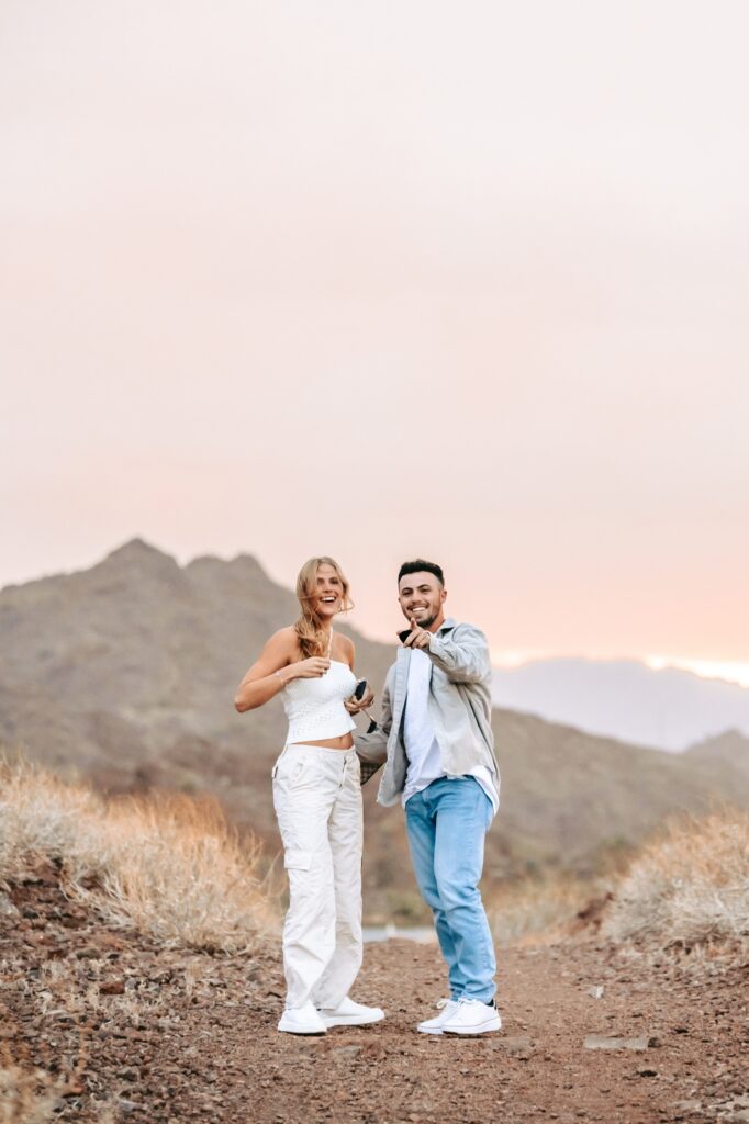 man pointing out surprise marriage proposal photographer