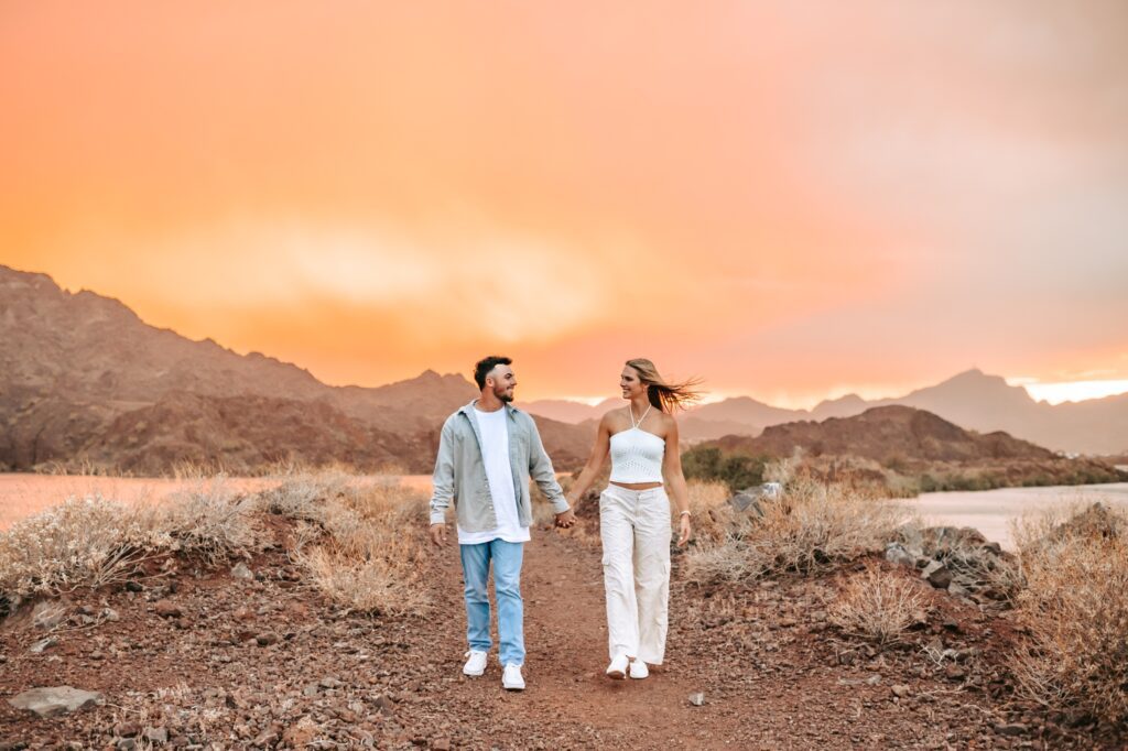 couple walking together with the most incredible arizona sunset 