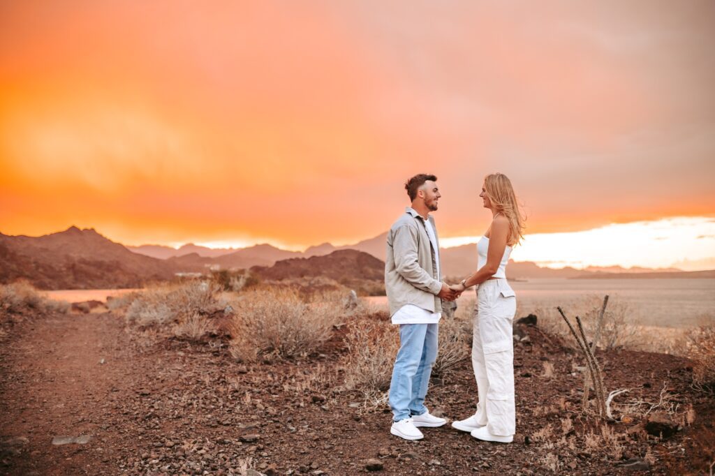couple standing together with the most incredible arizona sunset 