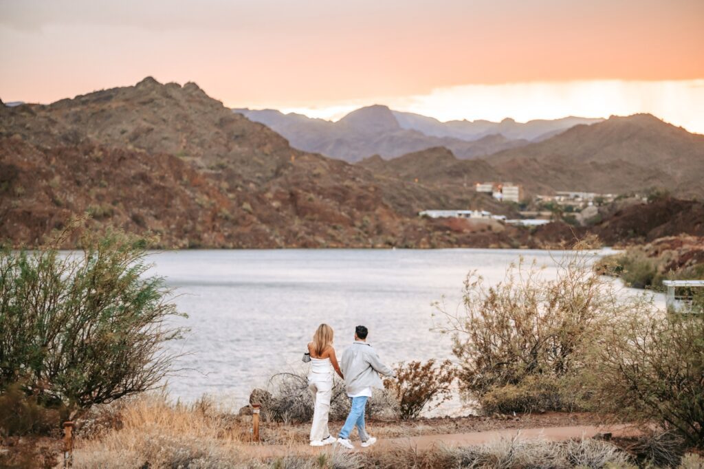 couple walking together hand in hand by the colorado river
