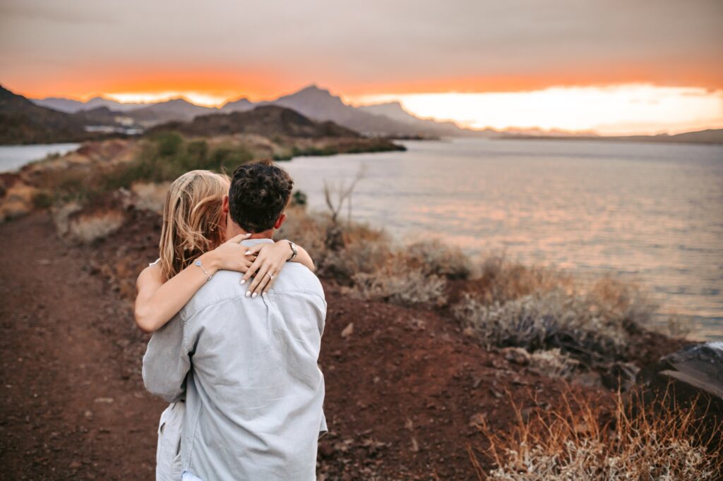 couple cuddling together  by the colorado river