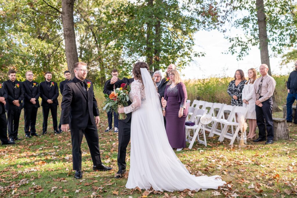 outdoor wedding ceremony in october at old coon creek inn in beloit