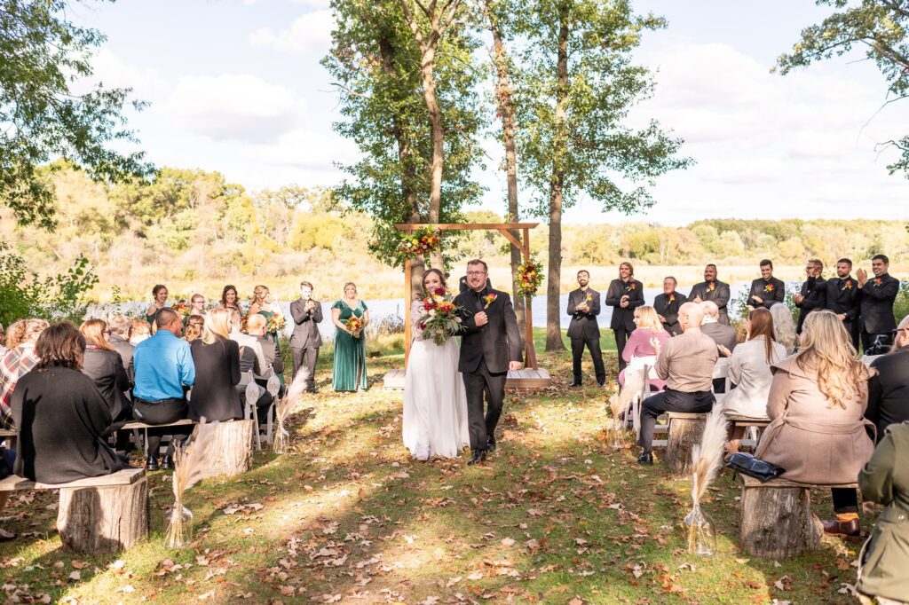 outdoor wedding ceremony in october at old coon creek inn in beloit