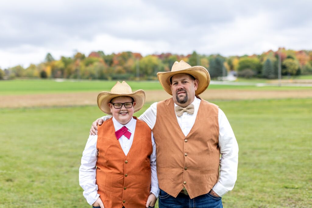 groom wearing a cowboy hat, bow tie and vest