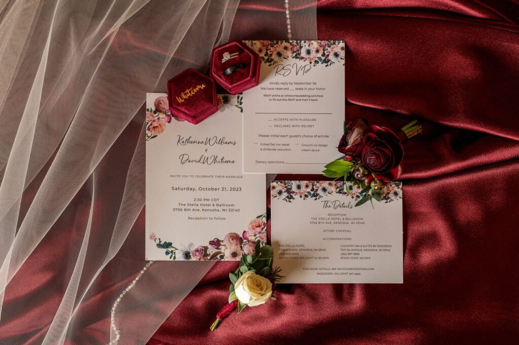 maroon and white wedding invitation suite with satin background