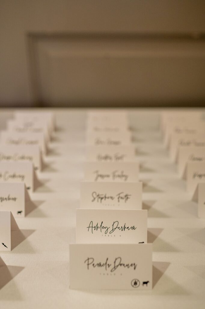 welcome table at wedding reception with seat assignment cards