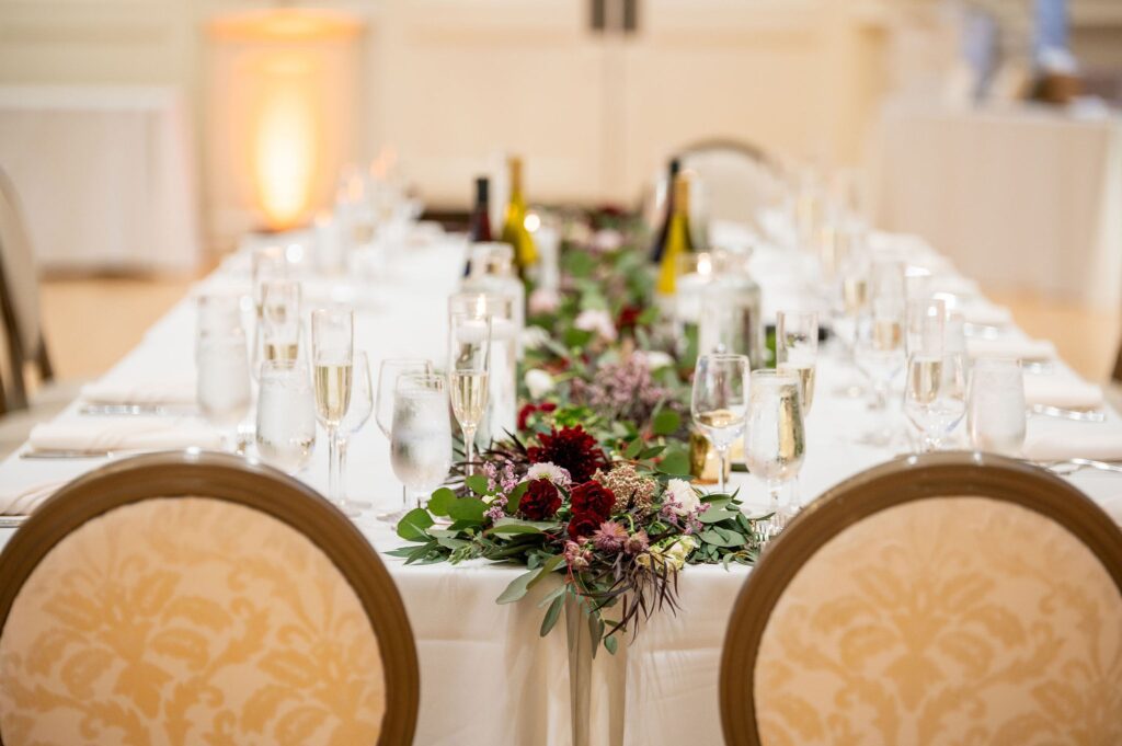 indoor wedding ceremony decor with floral table runners