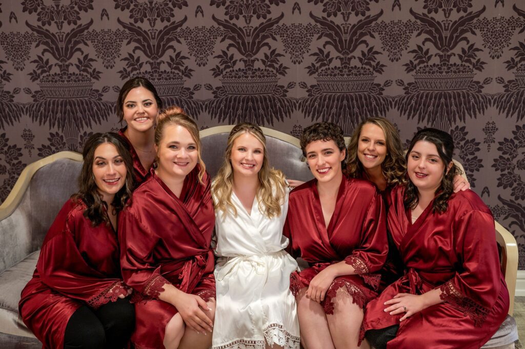bridesmaids in maroon getting ready robes