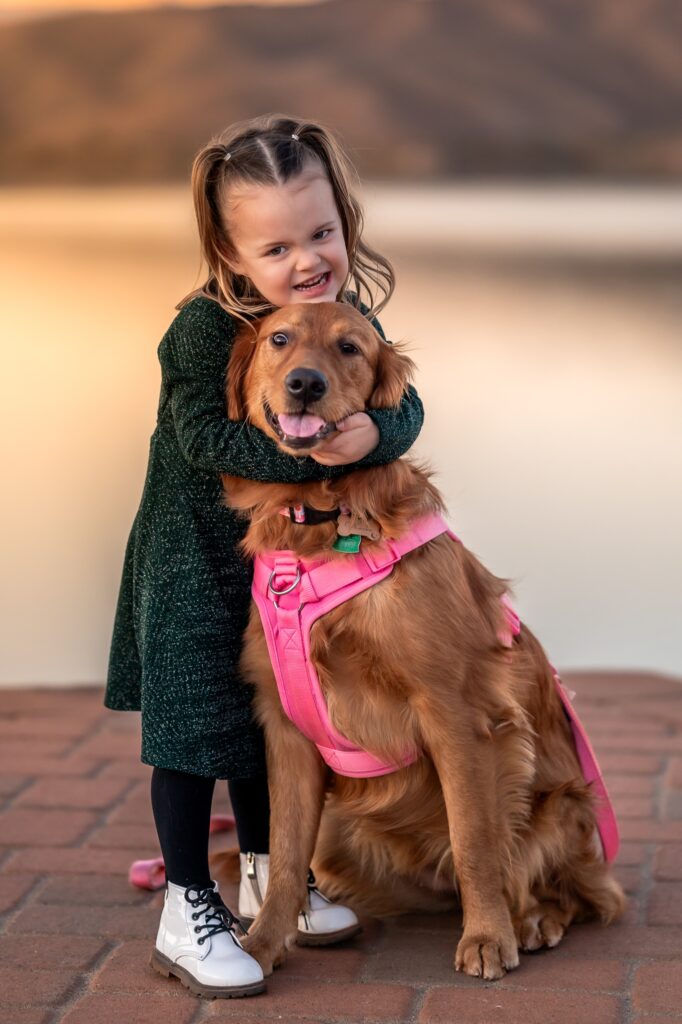 little girl with golden retriever dog