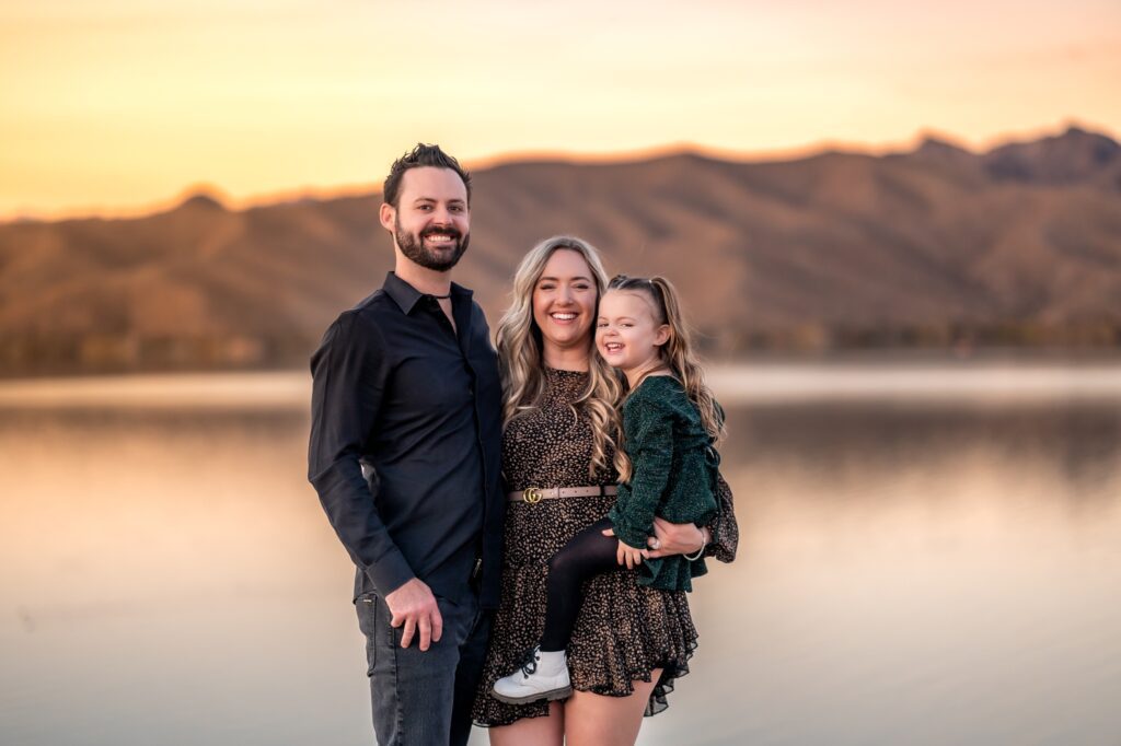family photos in front of arizona lake at sunset